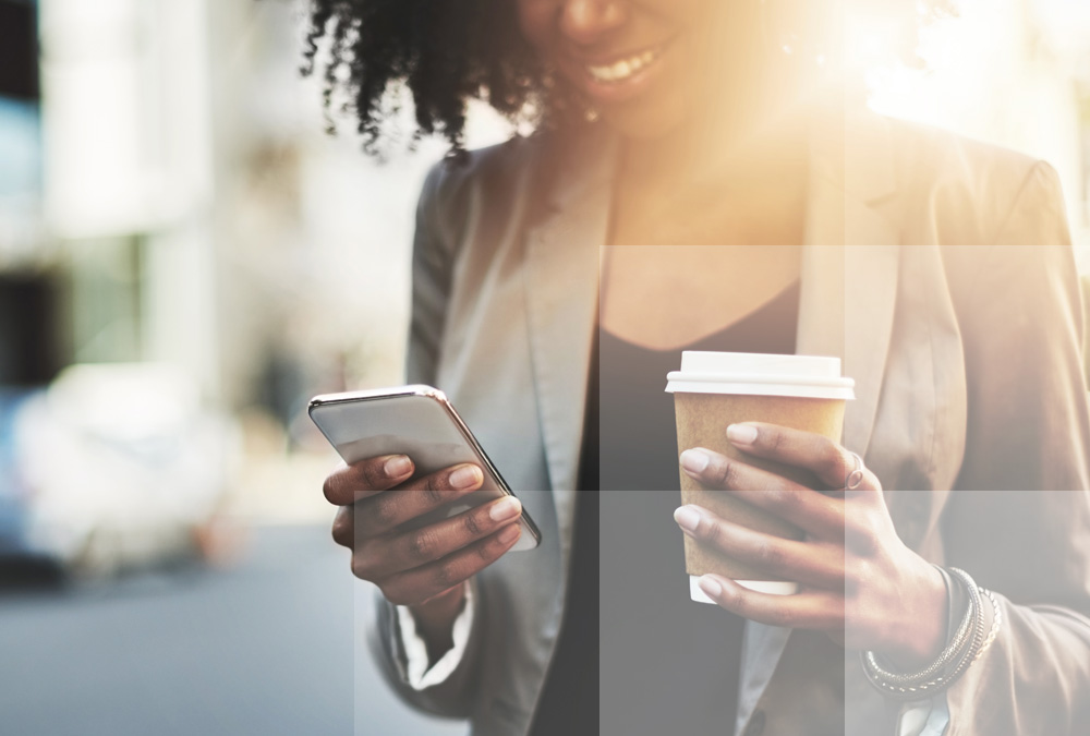 Woman using Datasite's data rooms on the go via a mobile device